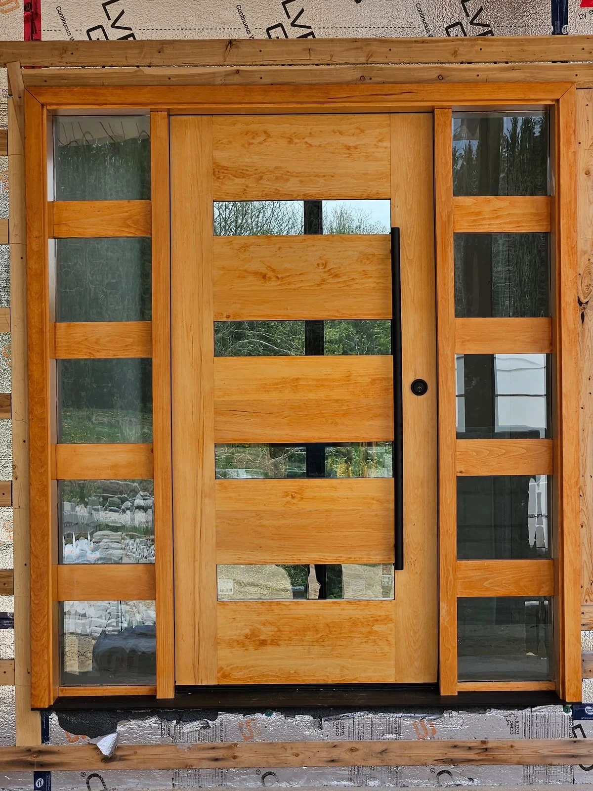 Contemporary wood door with horizontal glass and sidelights